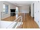 Upstairs living area features hardwood floors, contemporary railings, and a view of the cozy fireplace at 1490 N Crossing Circle Ne Cir # 1490, Atlanta, GA 30329