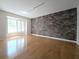 Spacious living room features hardwood floors, brick accent wall and sun-filled window at 1490 N Crossing Circle Ne Cir # 1490, Atlanta, GA 30329