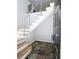 Entryway staircase features modern stainless steel railings and natural wood treads over neutral stone tile at 1490 N Crossing Circle Ne Cir # 1490, Atlanta, GA 30329