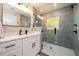 Modern bathroom features sleek vanity, a glass shower, and gray tiling at 2724 Parkwood Se Rd, Smyrna, GA 30080