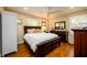 Comfortable bedroom with hardwood floors, a dark wood bed frame, and plantation shutters at 2724 Parkwood Se Rd, Smyrna, GA 30080