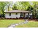 Charming white brick home with a cozy front porch and inviting landscaping at 2724 Parkwood Se Rd, Smyrna, GA 30080