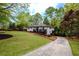Well-manicured lawn and driveway leading to a white home with a dark-stained front porch at 2724 Parkwood Se Rd, Smyrna, GA 30080