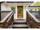 Inviting front door with wooden porch and white brick, with address number 2724 at 2724 Parkwood Se Rd, Smyrna, GA 30080
