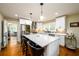 Bright kitchen featuring white cabinets, a spacious island with bar seating, and modern appliances at 2724 Parkwood Se Rd, Smyrna, GA 30080