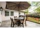 Outdoor patio with an umbrella, a table and chairs, and backyard views at 2724 Parkwood Se Rd, Smyrna, GA 30080
