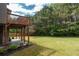 Expansive backyard featuring a well-maintained lawn, mature trees, and an upper deck great for outdoor enjoyment at 3880 Deer Run Dr, Cumming, GA 30028