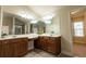 A spacious bathroom featuring double vanity sinks, with nice mirrors and lighting at 3880 Deer Run Dr, Cumming, GA 30028
