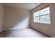 Cozy bedroom with neutral tones, plush carpeting, and a large window providing natural light at 3880 Deer Run Dr, Cumming, GA 30028
