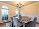 Dining room with chair rail molding, chandelier, area rug, and large dining table at 3880 Deer Run Dr, Cumming, GA 30028