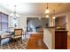 Open concept dining area with hardwood floors flows to living room and kitchen at 3880 Deer Run Dr, Cumming, GA 30028