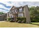 View of the side of the home showcasing the yard, landscaping and exterior finishings at 3880 Deer Run Dr, Cumming, GA 30028