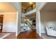 Bright foyer with hardwood floors, staircase with iron railing, and a view into the living spaces at 3880 Deer Run Dr, Cumming, GA 30028