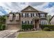 Charming two-story home with a two-car garage, brick accents, and well-maintained landscaping at 3880 Deer Run Dr, Cumming, GA 30028