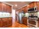 A gourmet kitchen featuring stainless steel appliances and ample wood cabinetry at 3880 Deer Run Dr, Cumming, GA 30028