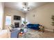 Open concept living room featuring a ceiling fan, fireplace and comfortable seating at 3880 Deer Run Dr, Cumming, GA 30028