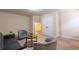 Comfortable living room featuring a sofa, two chairs, a round table, and a closet with double doors at 3880 Deer Run Dr, Cumming, GA 30028