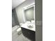 Modern bathroom boasts gray marble walls, backlit mirror, and sleek vanity at 6125 Connell Rd, Atlanta, GA 30349