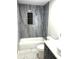 Renovated bathroom with tub shower combo, stylish grey marbled walls and new vanity at 6125 Connell Rd, Atlanta, GA 30349