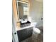 Bathroom with a stylish vessel sink, illuminated mirror, and modern tile flooring at 6125 Connell Rd, Atlanta, GA 30349