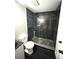Elegant bathroom featuring a modern shower, with green tile, and dark fixtures at 6125 Connell Rd, Atlanta, GA 30349