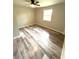 Bedroom with gray, wood-look flooring and a ceiling fan at 6125 Connell Rd, Atlanta, GA 30349