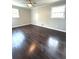 The bedroom has windows that provide natural light and beautiful hardwood floors at 6125 Connell Rd, Atlanta, GA 30349
