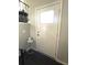 Bright and inviting entry door with decorative window pane and dark wood-style floors at 6125 Connell Rd, Atlanta, GA 30349