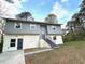 Charming two-story home with light gray and white exterior and well-maintained landscaping at 6125 Connell Rd, Atlanta, GA 30349