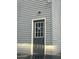 Exterior of home with gray siding and a gray door with windowpanes at 6125 Connell Rd, Atlanta, GA 30349