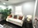 Cozy living room featuring a comfortable sofa, stylish decor, and ample natural light at 6125 Connell Rd, Atlanta, GA 30349