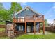 The back exterior has a wooden deck and a stone fireplace at 650 Ira Sw St, Atlanta, GA 30312
