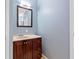 Bathroom featuring a vanity with a countertop, wood cabinets, and a mirror at 650 Ira Sw St, Atlanta, GA 30312