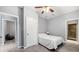 Neutral bedroom featuring tiled floors, gray walls, ceiling fan, and doorways to other rooms at 650 Ira Sw St, Atlanta, GA 30312