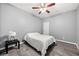 Bedroom featuring tiled floors, gray walls, ceiling fan, and minimal furniture at 650 Ira Sw St, Atlanta, GA 30312