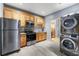 Charming kitchen with stainless steel appliances and wood cabinets, plus a convenient stacked washer and dryer at 650 Ira Sw St, Atlanta, GA 30312