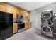 Charming kitchen with stainless steel appliances and wood cabinets, plus a convenient stacked washer and dryer at 650 Ira Sw St, Atlanta, GA 30312