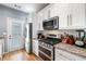 Modern kitchen features stainless steel appliances, granite countertops, and ample cabinet space at 650 Ira Sw St, Atlanta, GA 30312