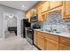 Well-appointed kitchen features light wood cabinets, stainless steel appliances, and herringbone floors at 650 Ira Sw St, Atlanta, GA 30312