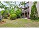 View of private backyard featuring lush greenery and a two-story deck at 2250 W Village Junction Se Way, Smyrna, GA 30080