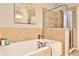 Bathroom with soaking tub and separate shower with light brown tile and chrome fixtures at 2250 W Village Junction Se Way, Smyrna, GA 30080