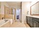Bathroom showcases a bathtub and glass shower with tiled walls and floor, and a vanity at 2250 W Village Junction Se Way, Smyrna, GA 30080