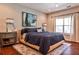 Cozy bedroom features a large bed, side tables with lamps, and a large window with natural light at 2250 W Village Junction Se Way, Smyrna, GA 30080