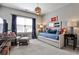 Bedroom with blue accents featuring comfortable seating, decor, and bright natural light at 2250 W Village Junction Se Way, Smyrna, GA 30080