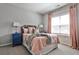 Bedroom features a plush bed with soft bedding, natural light, and pink curtains at 2250 W Village Junction Se Way, Smyrna, GA 30080