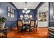 Stylish dining room with blue walls, contemporary lighting, and a view into the adjoining room at 2250 W Village Junction Se Way, Smyrna, GA 30080