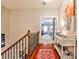 Upstairs hallway with hardwood floors and view into bedroom with tray ceiling at 2250 W Village Junction Se Way, Smyrna, GA 30080