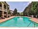 Community pool with plenty of lounge chairs and an outdoor seating area at 2250 W Village Junction Se Way, Smyrna, GA 30080