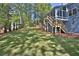 Spacious landscaped backyard with lush lawn and mature trees at 3015 Larkspur Ct, Cumming, GA 30041