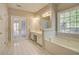 Bathroom with double doors, double sinks, bathtub, and a tile floor at 3015 Larkspur Ct, Cumming, GA 30041